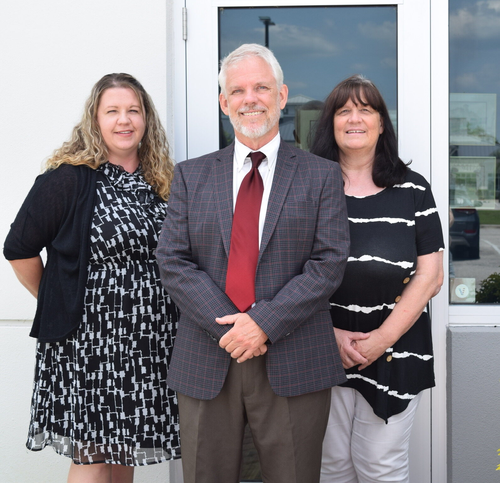 Bart Scovill with team members in front of University Park law office